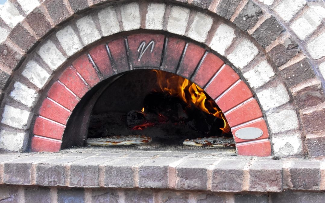 Wood-fired pizza oven on the Willow Brook Village courtyard, where outdoor dining events bring residents together at this Delaware, Ohio senior living community.